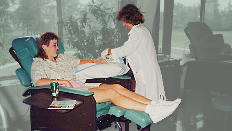 Bonnie at 21, sitting in a treatment chair, receiving chemotherapy as part of her cancer journey, a pivotal moment in her path to holistic wellness.